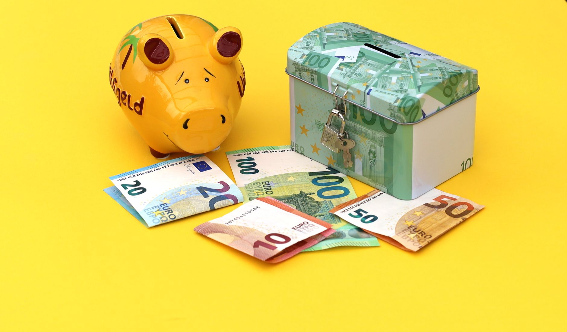 colorful euro banknotes with piggy bank and cash box