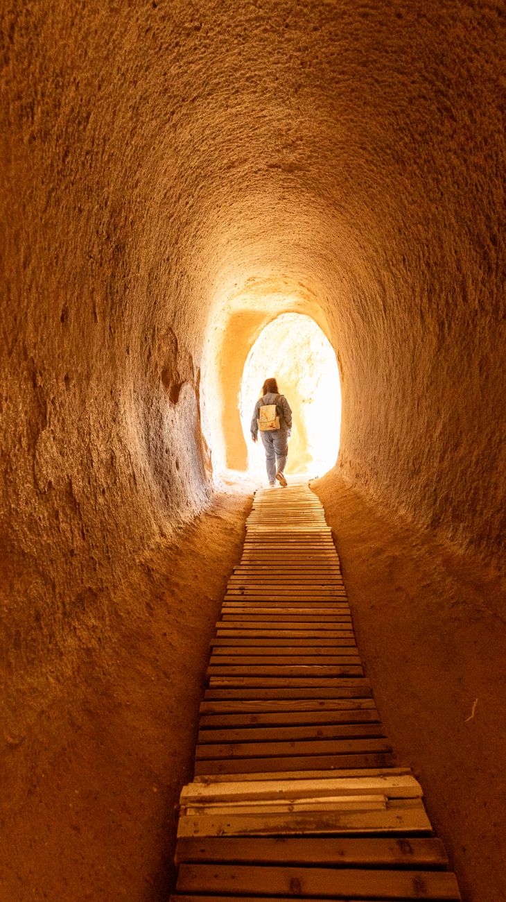 pexels-photo-31557994 traveler walking through cappadocia tunnel