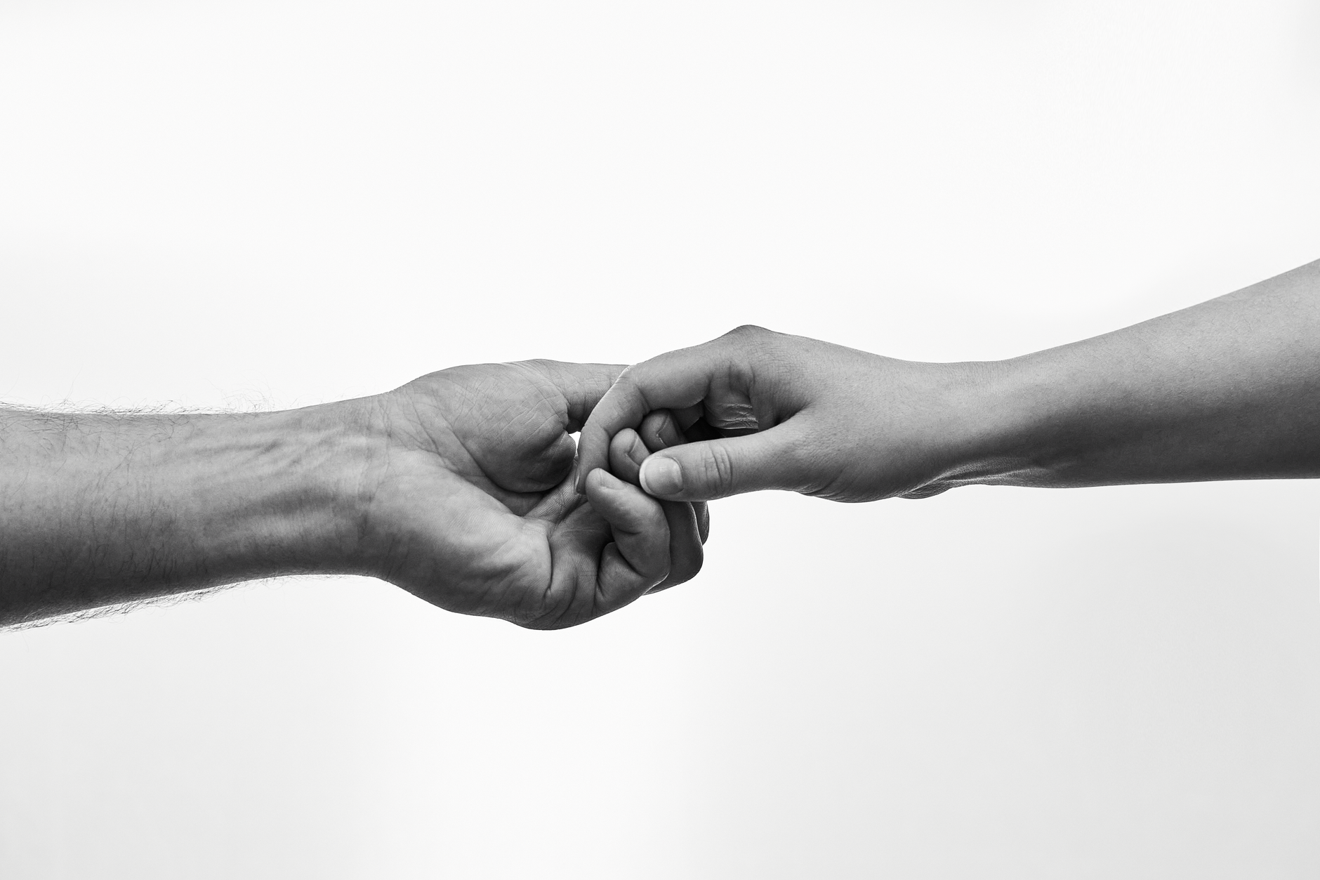 close up of two hands reaching out in connection