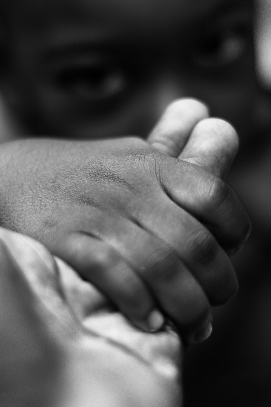 pexels-photo-5598393 faceless child holding hand of person