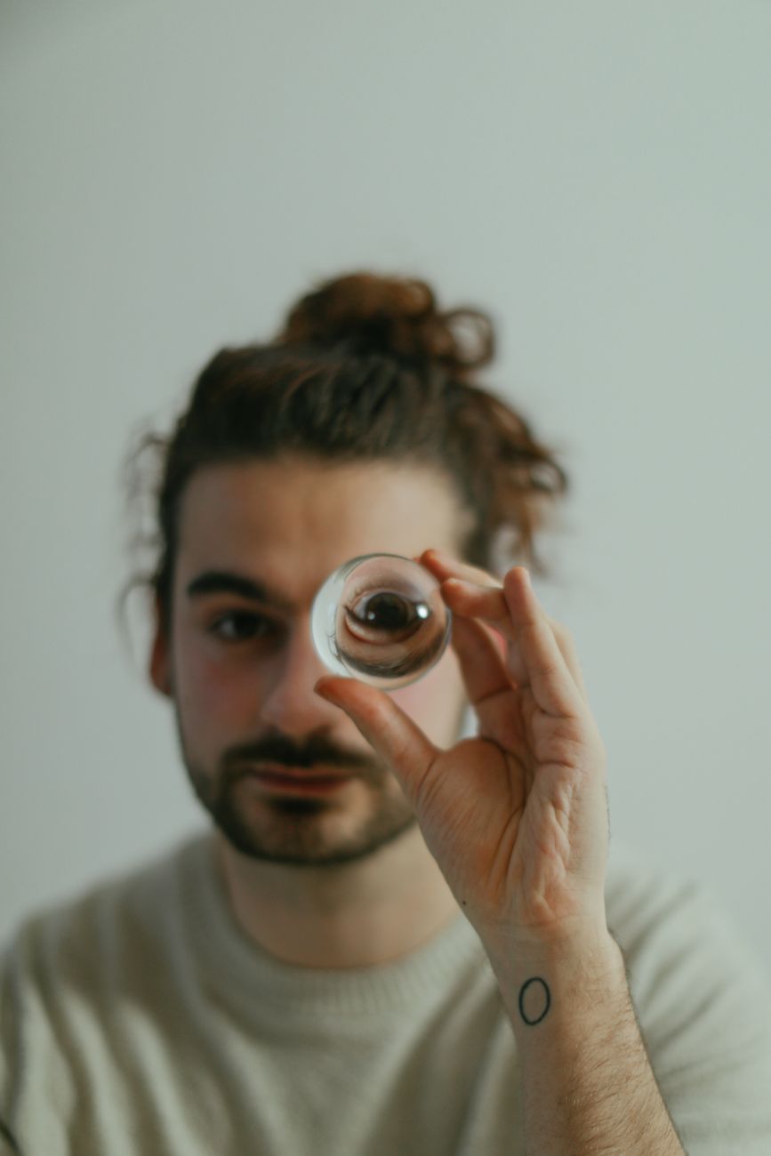 pexels-photo-6634477 a man holding a clear glass ball